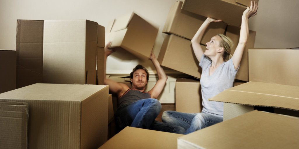 Couple with boxes who received an answer how to rent storage space.