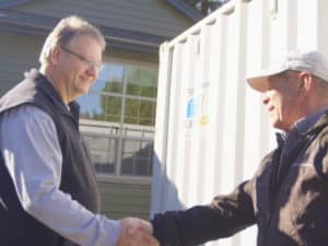 Simple Box employee gives kind handshake to customer
