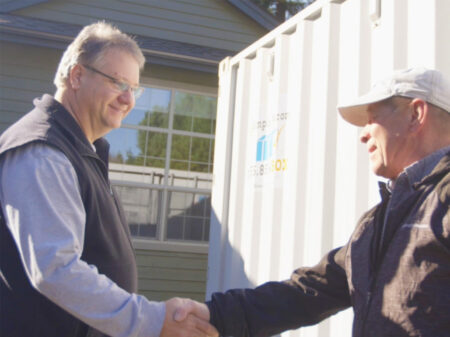 Simple Box employee gives kind handshake to customer