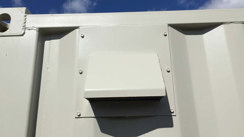 Insta vent on a shipping container, painted beige.