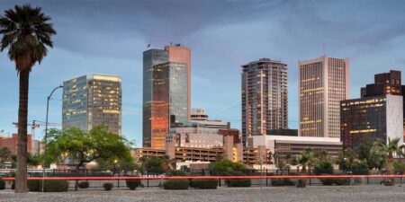 Wide angle shot of downtown Phoenix, Arizona skyscrapers and palm trees.