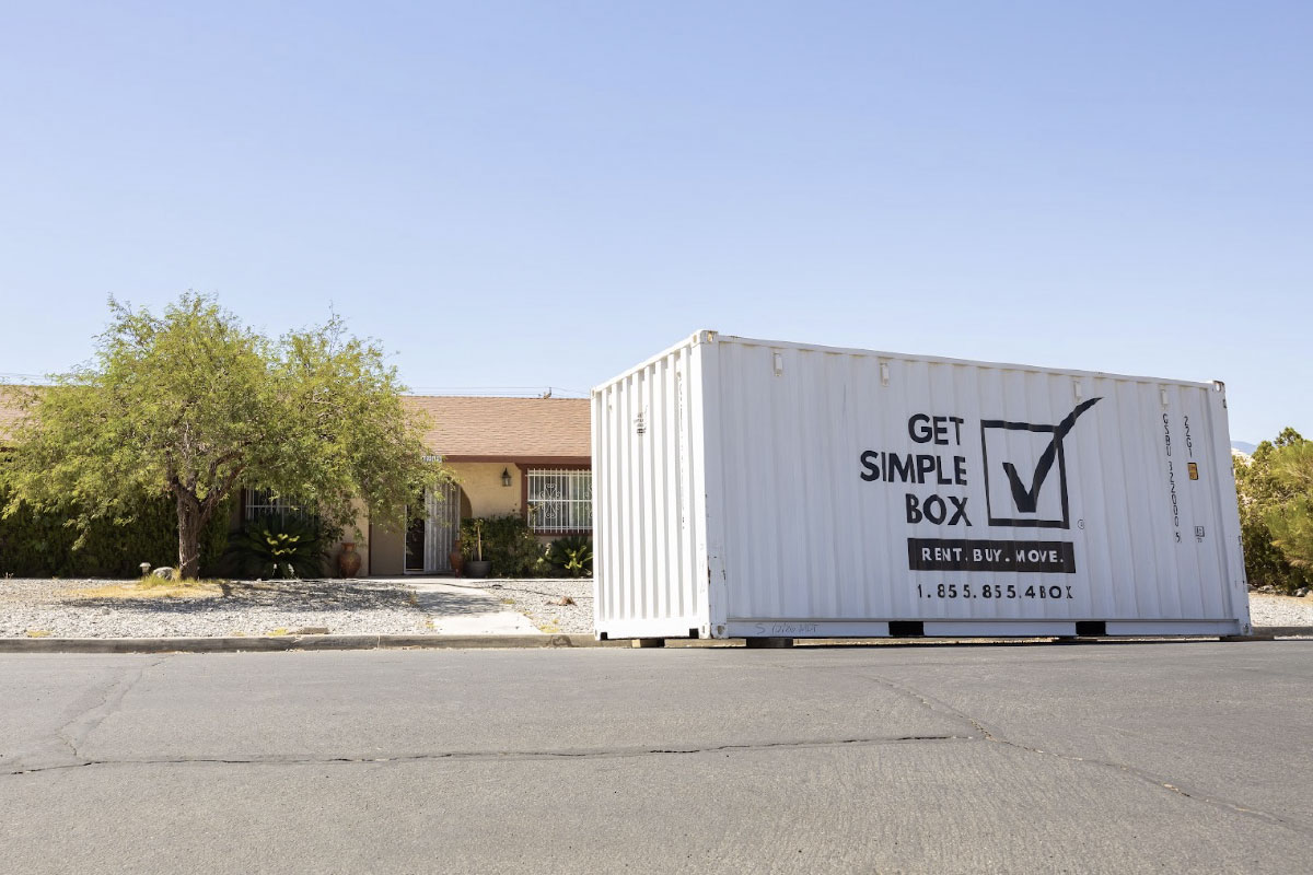 A Get simple Box Shipping container delivered in front of a home.