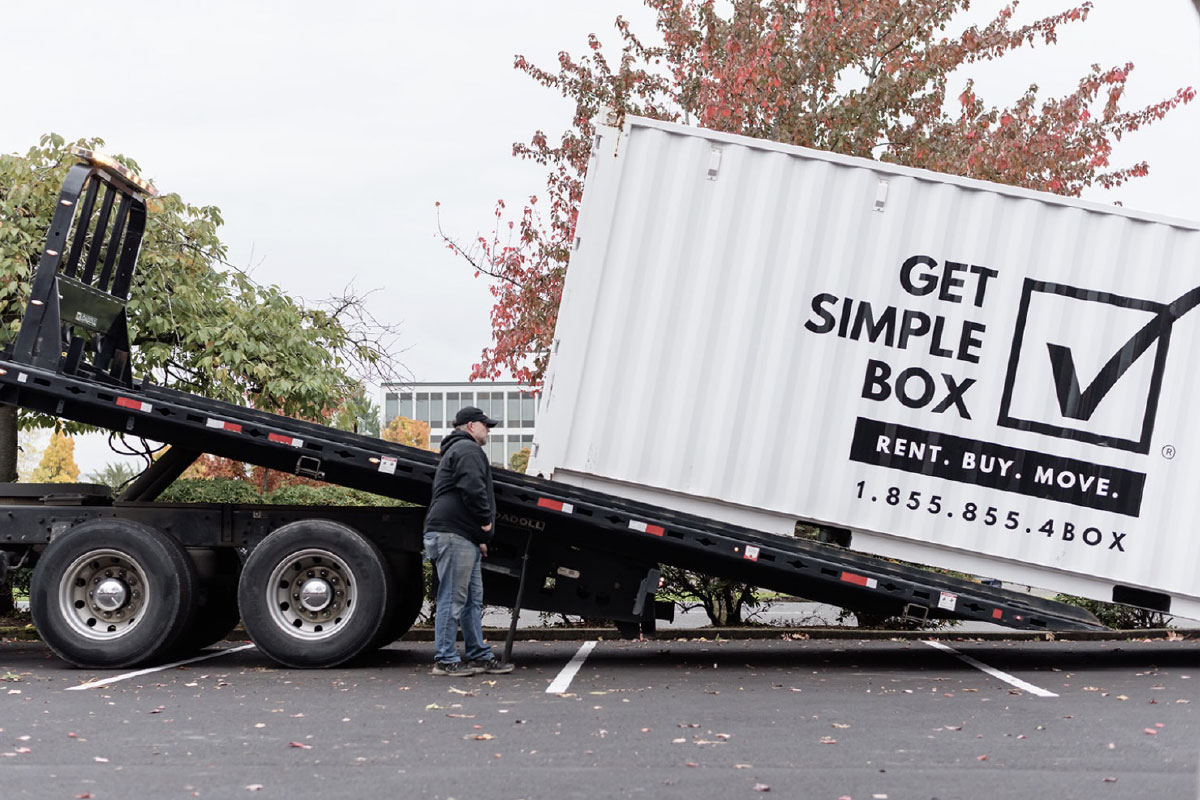 Unloading a shipping container, it is a white box.