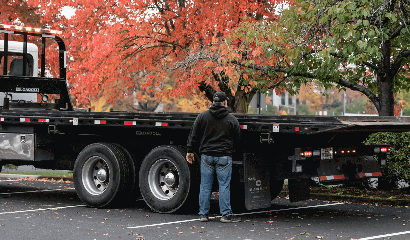 A person standing in front of the truck back.