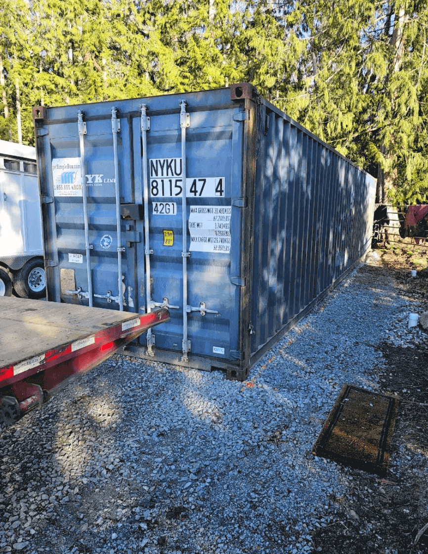 Blue shipping container unloaded in a parking place with Get Simple Box Logo