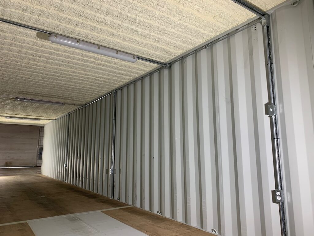 Roof of a shipping container with spray foam insulation