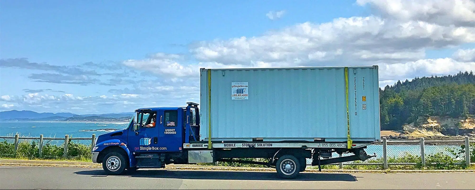 Truck with a 20 foot shipping container being delivered.