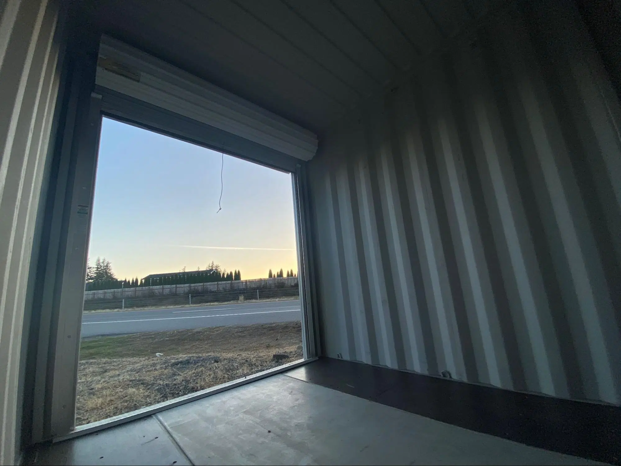 Inside of a 10 foot shipping container with a roll up door