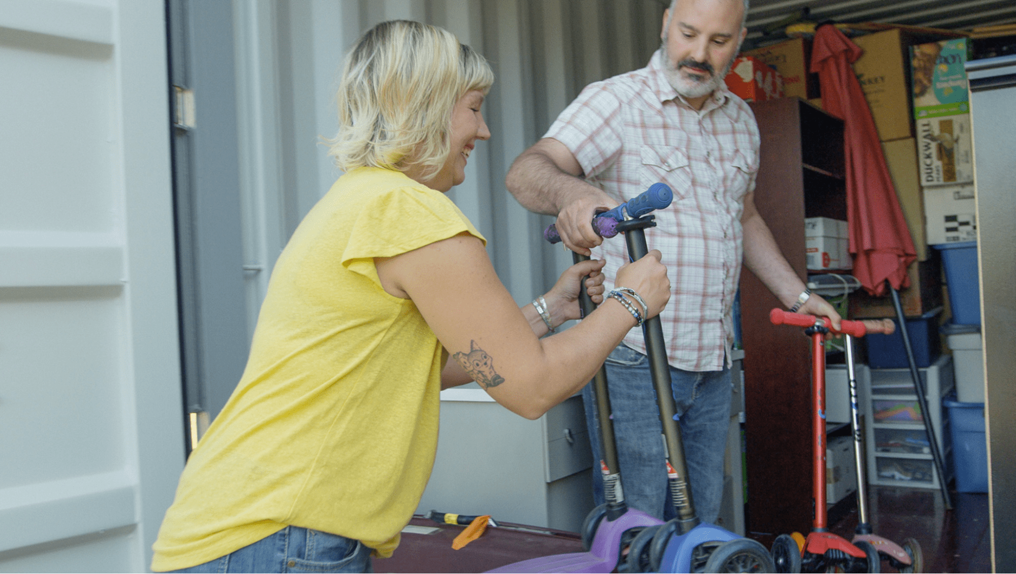 Couple unpacking boxes by themselves from a shipping container