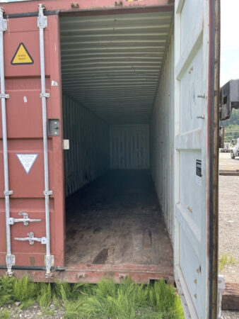 Open shipping container with lockbox on door