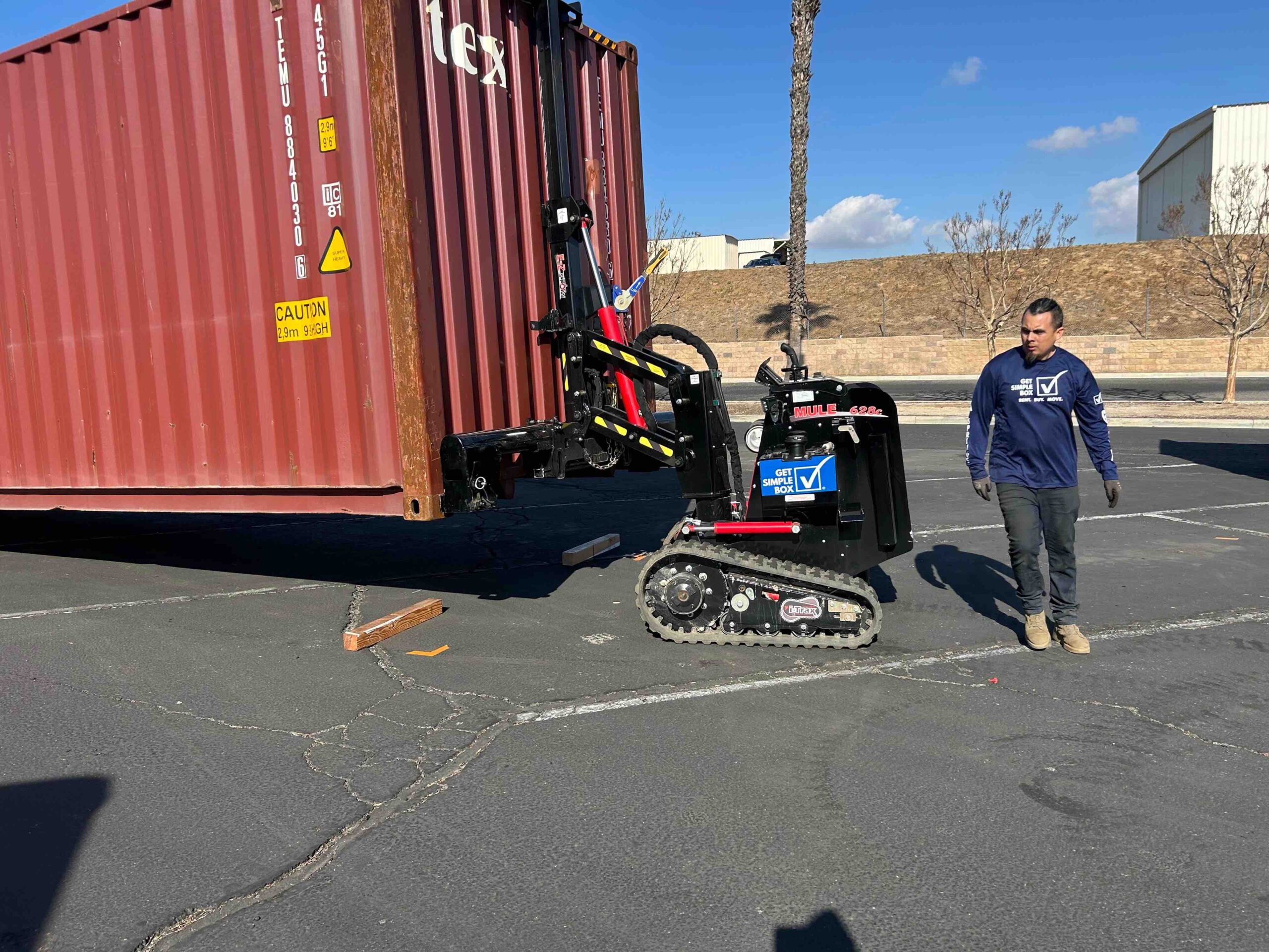 Team members from Get Simple Box and Harvest Fellowship coordinate container placement at the Riverside relief hub.