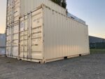 20ft new shipping container parked with other containers in a yard