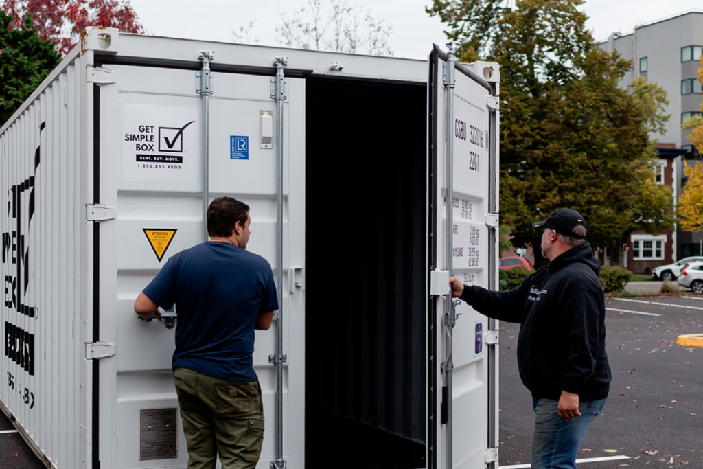 Team member showing a customer how to open a storage container in Eugene, OR