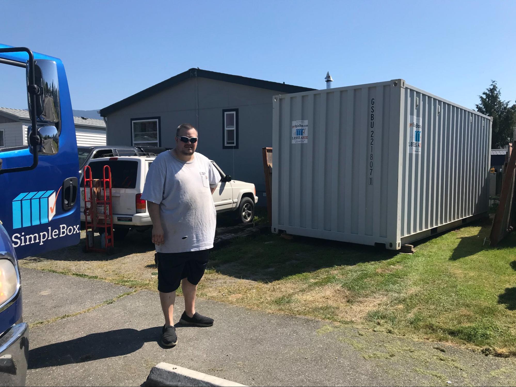 A Goodyear homeowner next to a portable storage container parked cleanly on a residential driveway.
