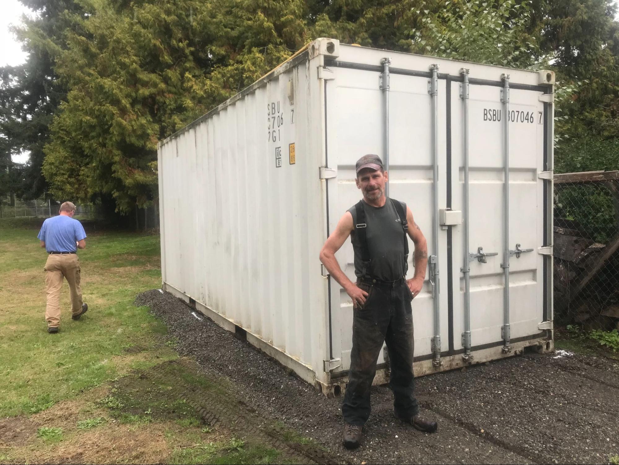 A customer inspecting used containers at a secure local storage lot.