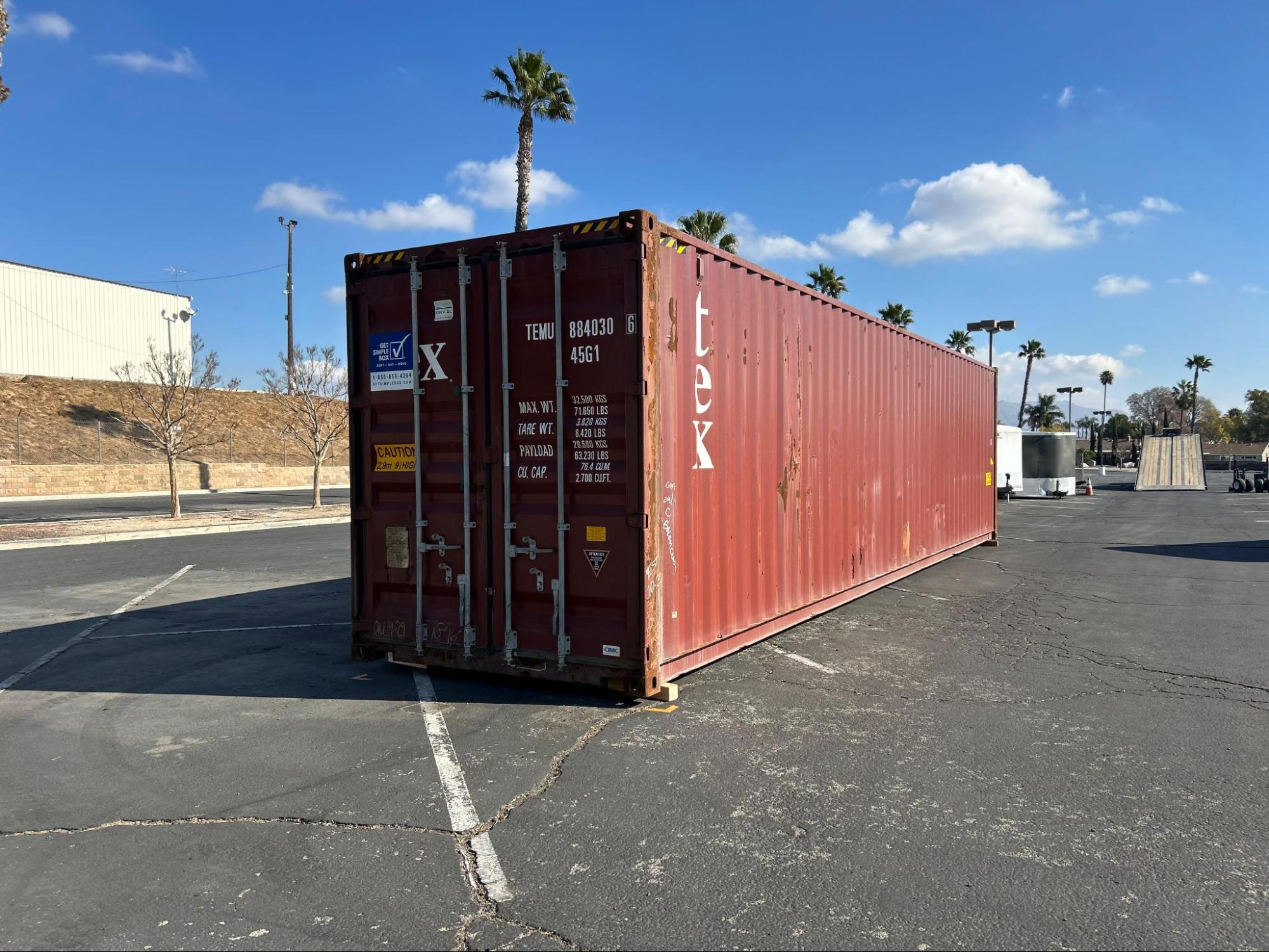 A structurally sound, used cargo worthy container showing typical cosmetic dings and shipyard patch-paint from international maritime service