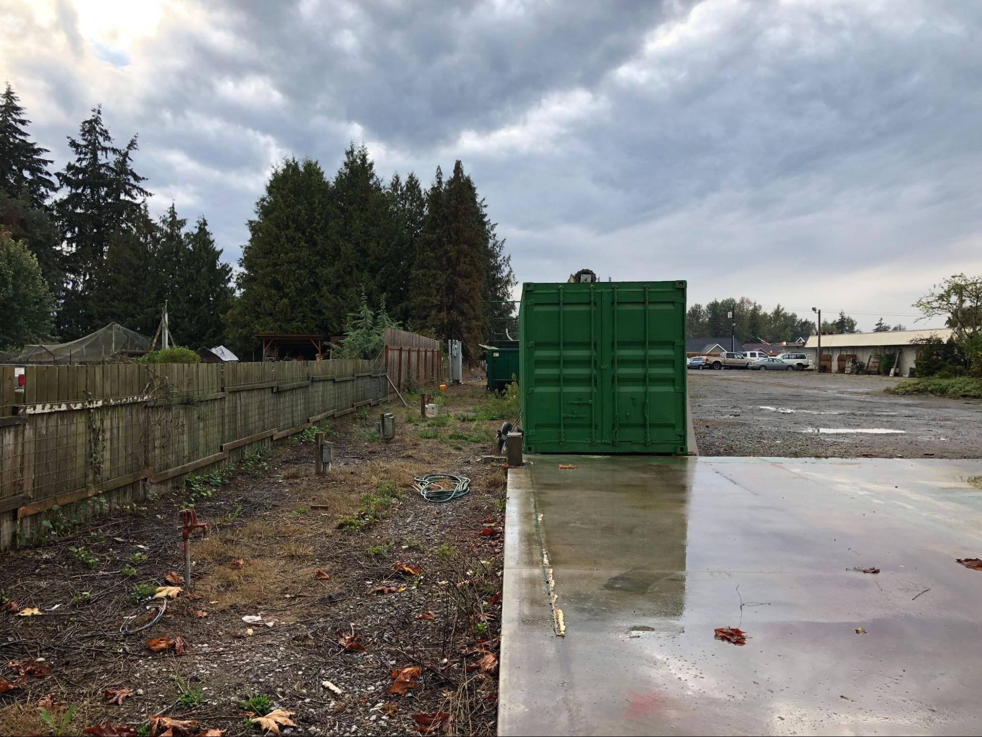 A weatherproof steel container keeping household belongings completely dry on a rainy day in Deming
