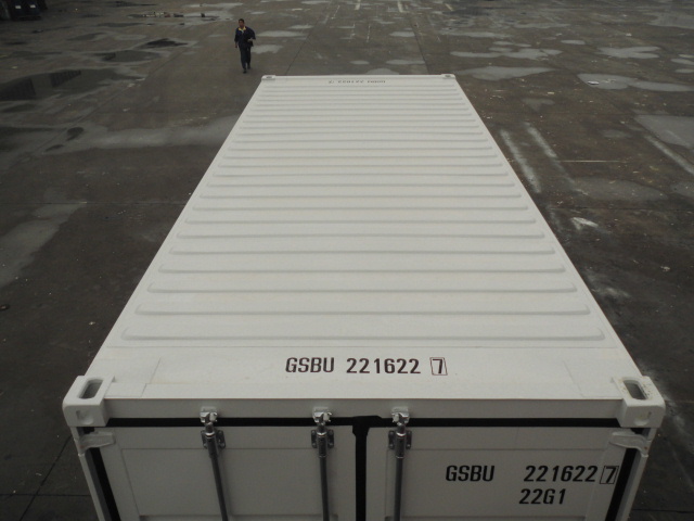 Applying a reflective white roof coat to a 40-foot shipping container in Sumas to repel intense summer heat
