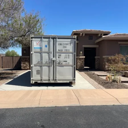 White storage container delivered in a residential driveway