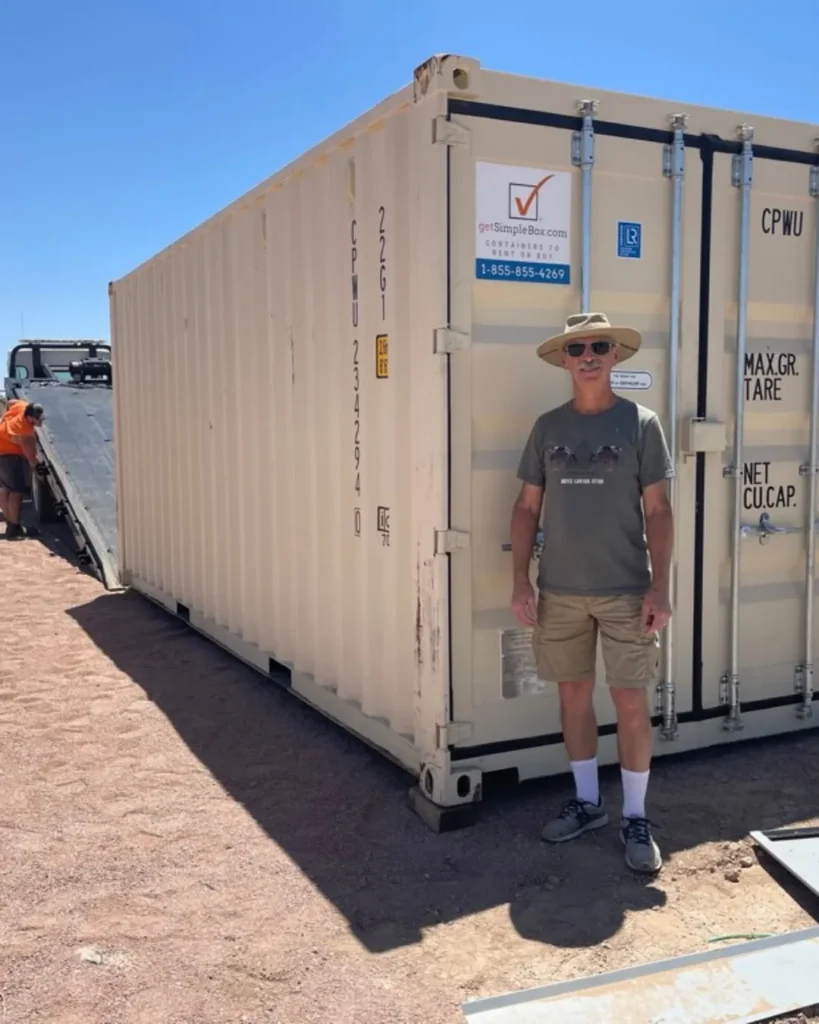 Customer standing beside a delivered shipping container