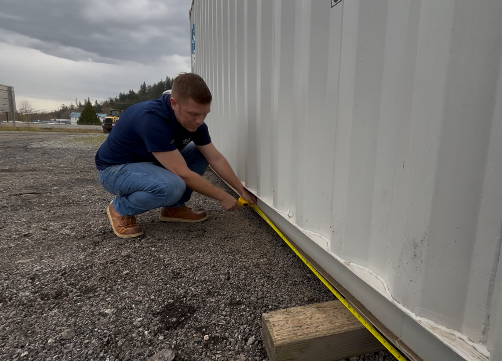 Customer inspecting used shipping containers for sale near me at a secure storage lot