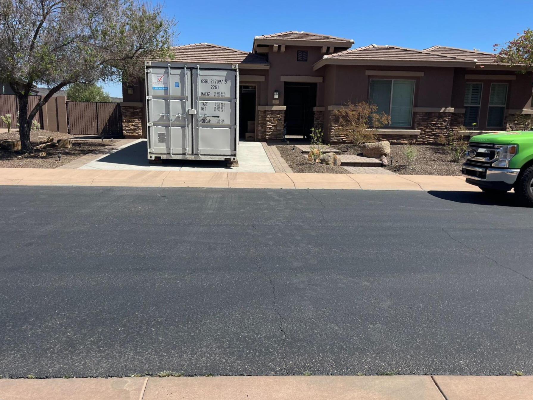 Get Simple Box local container delivery service setting a container in a residential driveway