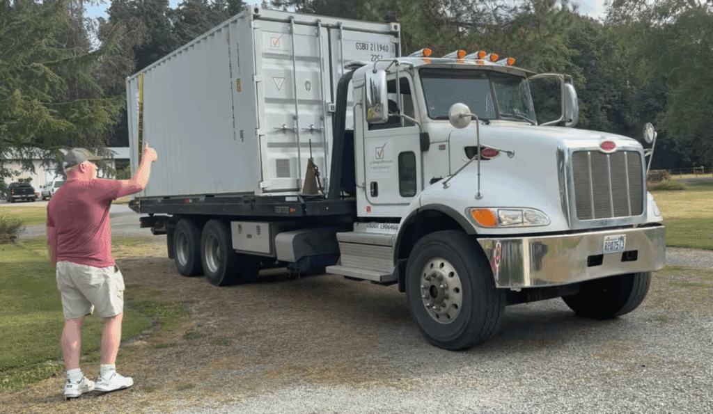 Customer next to a Get Simple Box truck carrying a white container