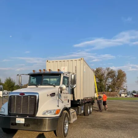 Get Simple Box truck delivering a white storage container