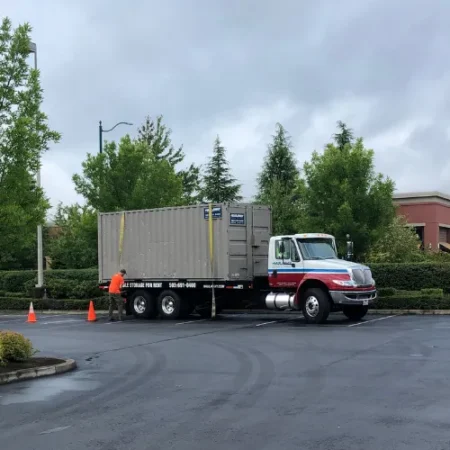 Storage container loaded on a delivery truck in a parking lot