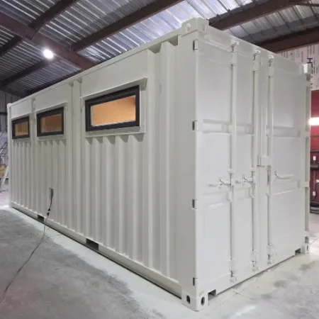 White office storage container with windows inside a warehouse
