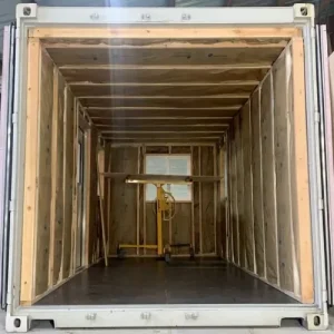 Modified storage container interior with framed walls and window