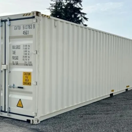 White high cube shipping container sitting on a gravel lot