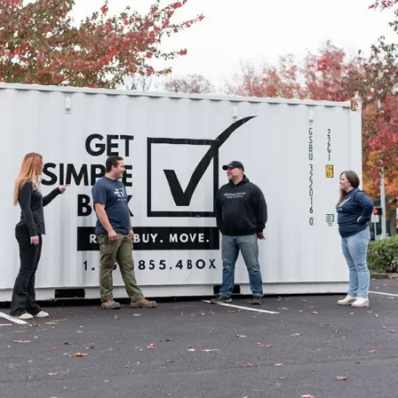 Get Simple Box team talking beside a branded storage container