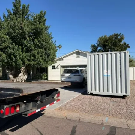 White storage container delivered in a residential driveway