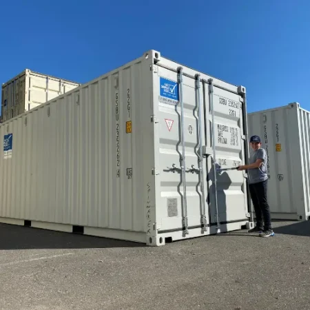 Customer opening the doors of a white shipping container
