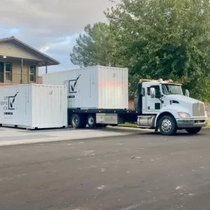 Get Simple Box truck delivering two white storage containers