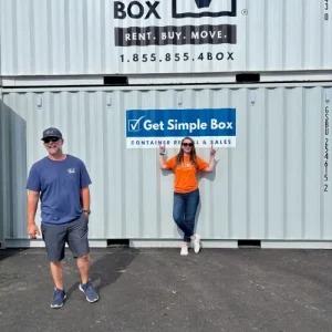 Get Simple Box team members standing in front of stacked storage containers