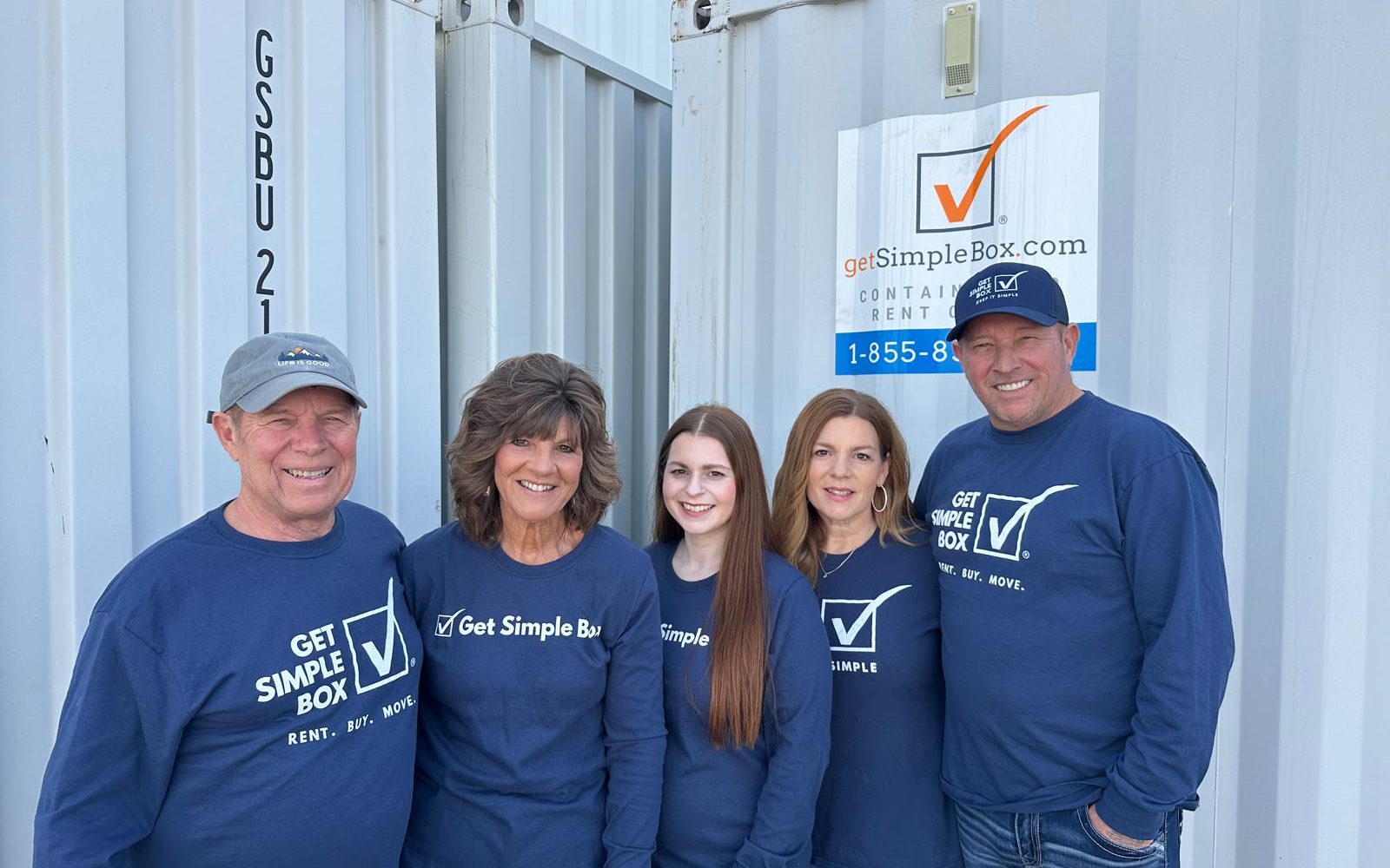Get Simple Box team members standing between portable storage containers at the company yard serving Goodyear, Arizona customers