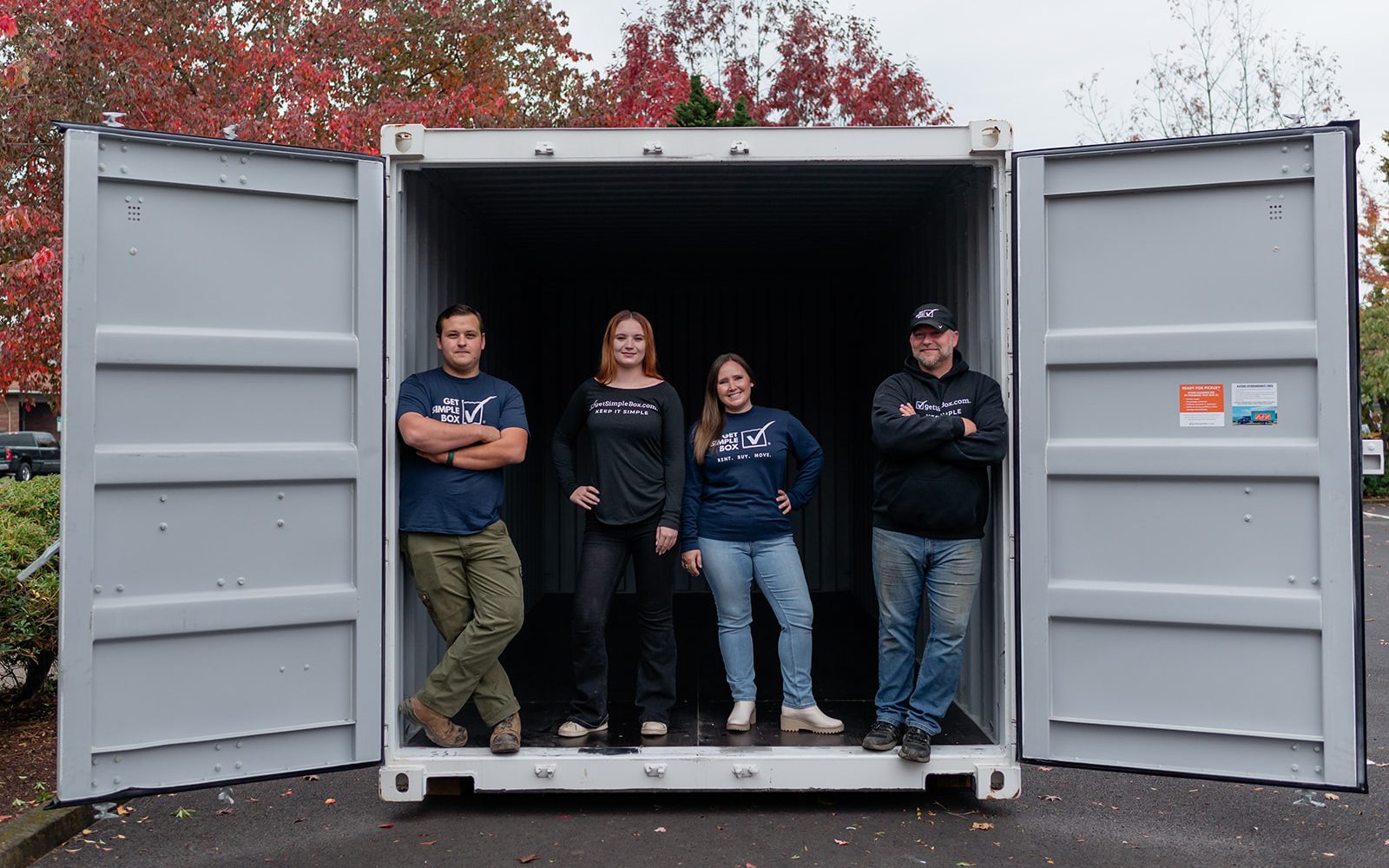 Keizer team standing inside an open Get Simple Box storage container