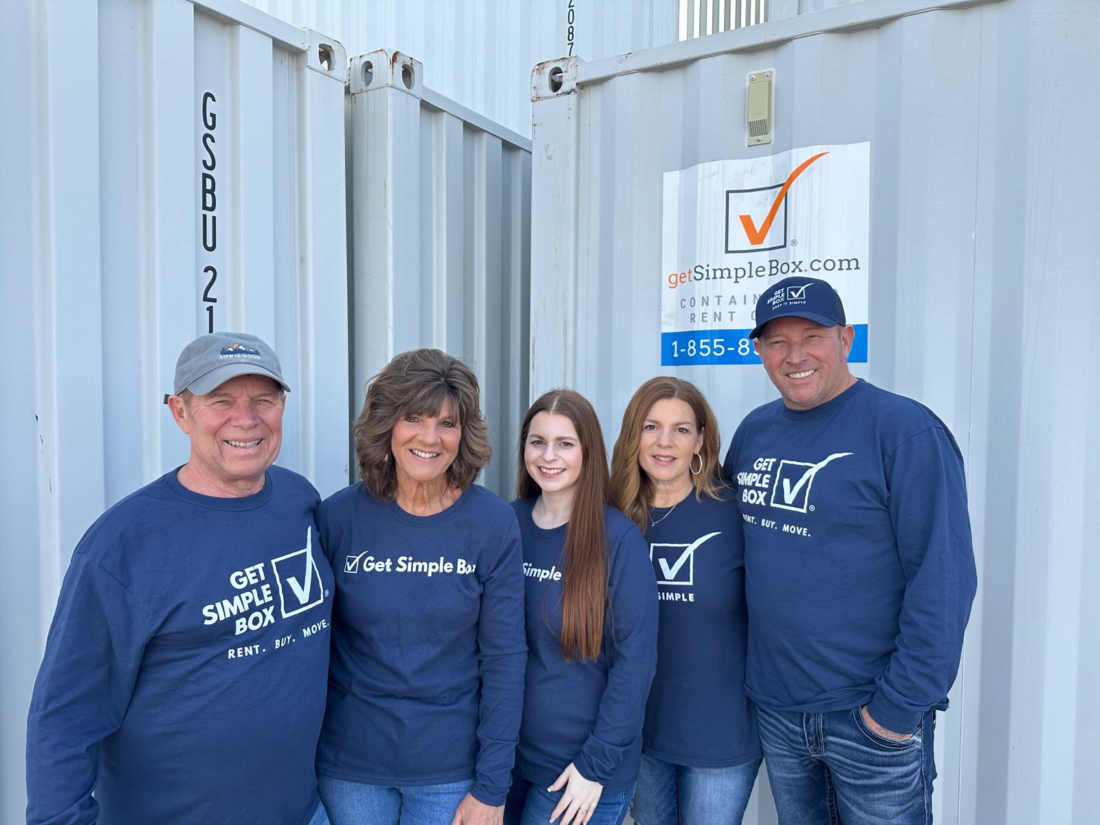 Get Simple Box team members standing together between storage containers at the Glendale, Arizona container yard