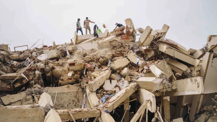 Rescue workers searching rubble after an earthquake